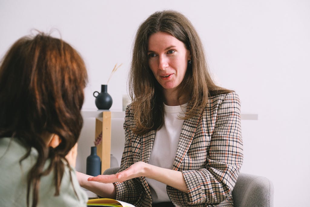 Two women engaged in a professional therapy session indoors.